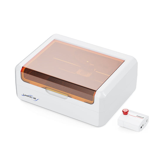 Compact desktop laser engraver in a home studio setting